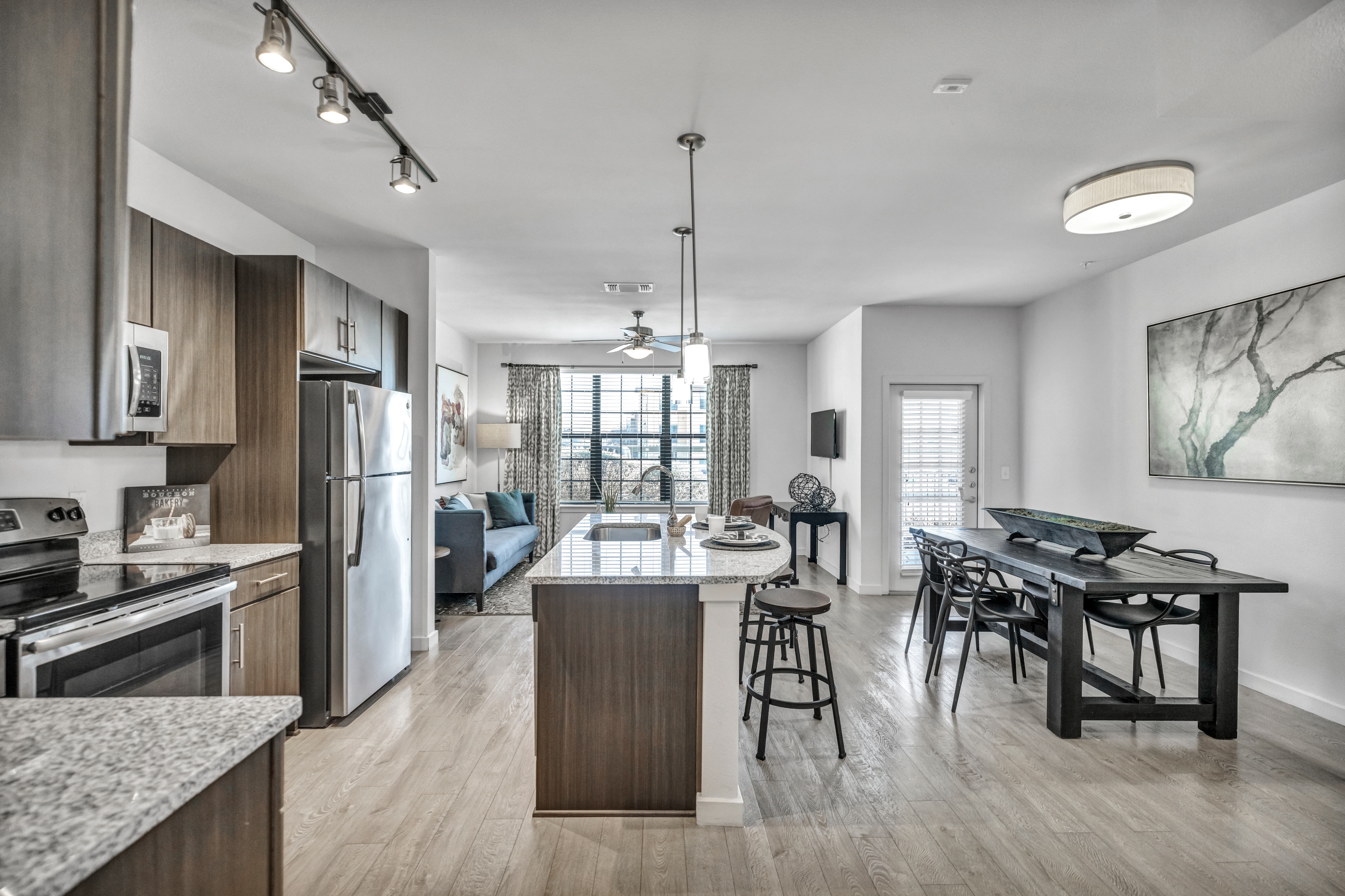 An interior room of Monterrey Village property, featuring modern decor, comfortable furnishings, and ample natural light streaming through the windows