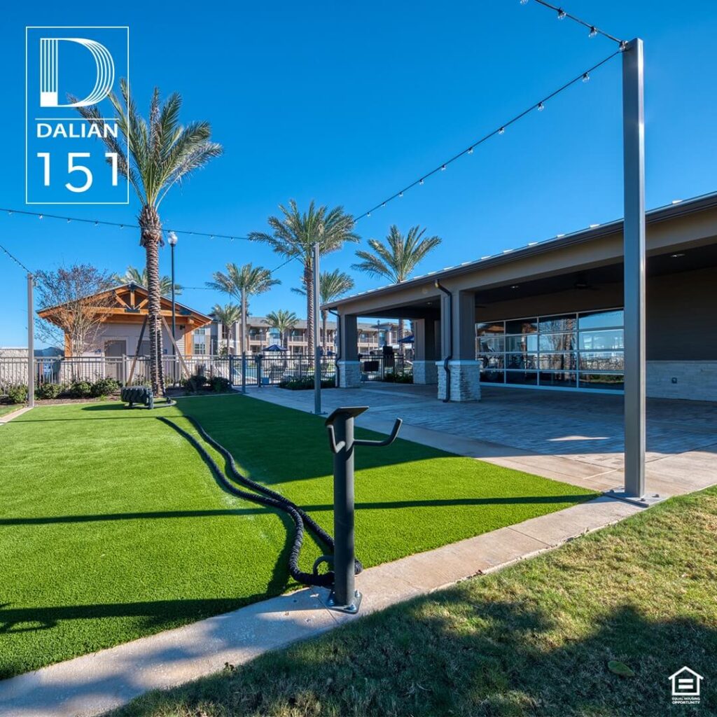 The outdoor fitness area at Dalian 151, featuring exercise equipment amidst lush greenery, providing residents with an opportunity for outdoor workouts and recreation