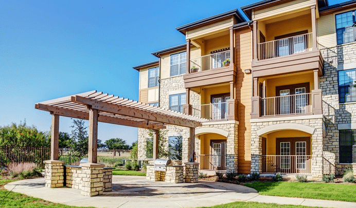 Exterior view of Monterrey Village property, showcasing its architecture, lush landscaping, and inviting outdoor spaces